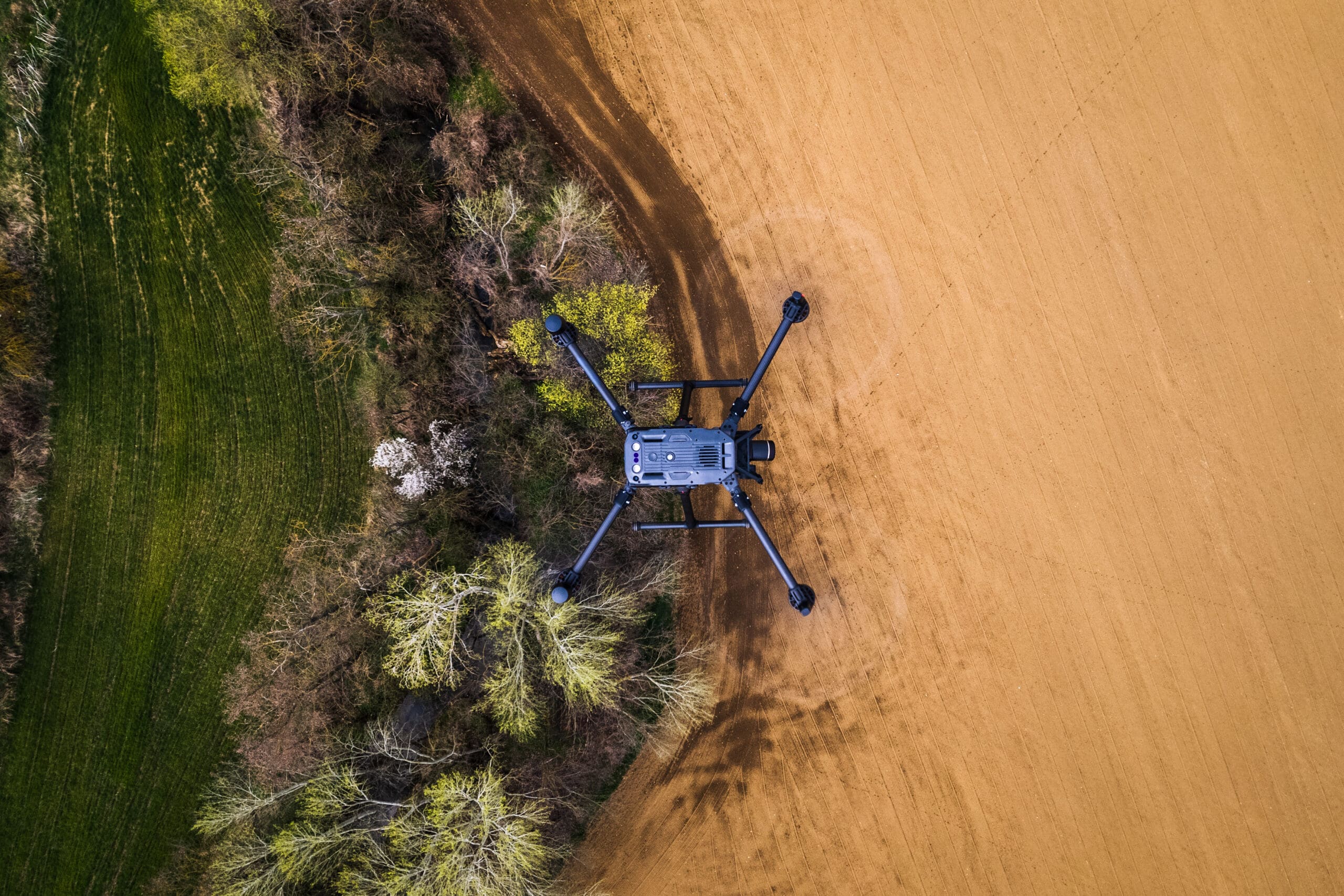 Drone survey flying over a field for agricultural inspections