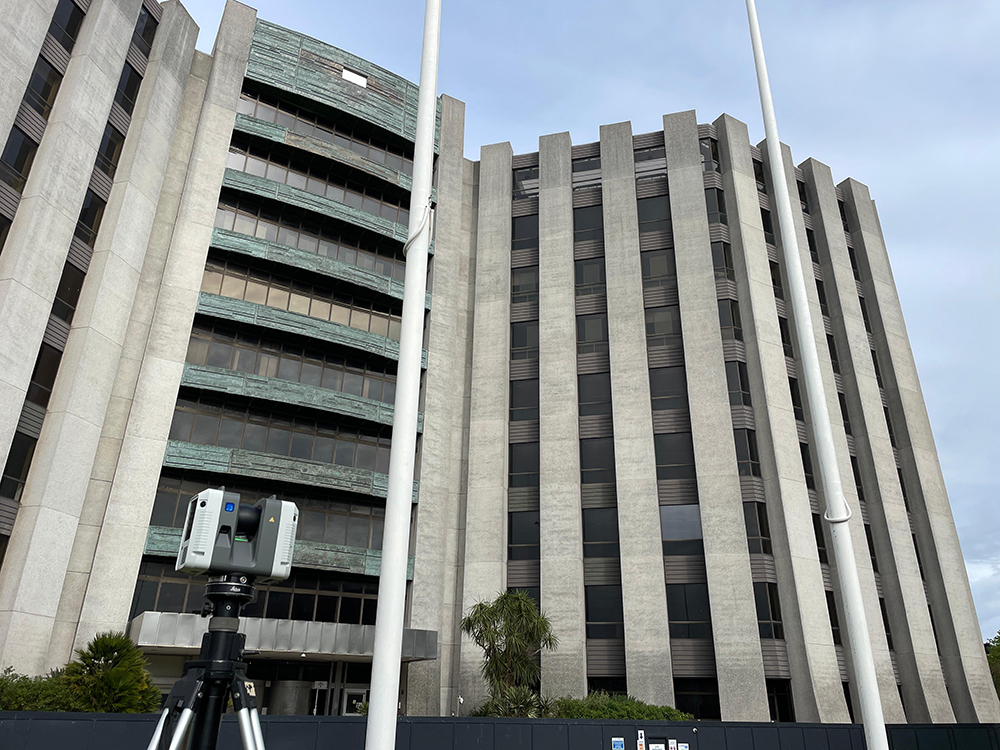 Laser scanner positioned at an office building for a measured building survey.